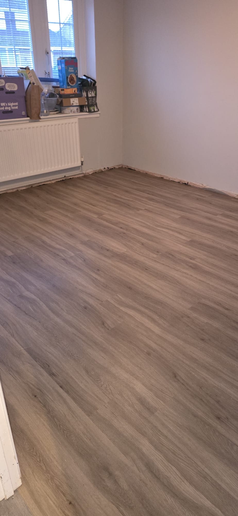 Grey oak plank flooring fitted in a bedroom in Northampton