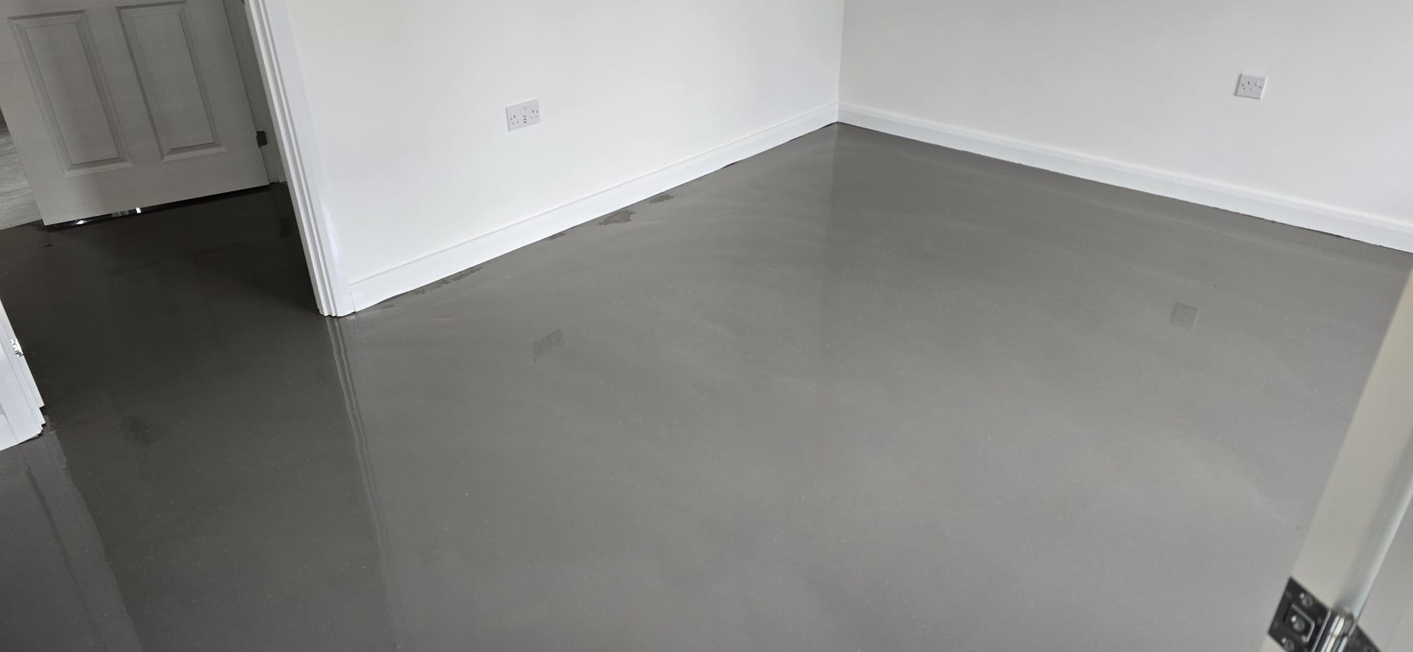 Freshly poured levelling compound on a lounge sub-floor before flooring is fitted
