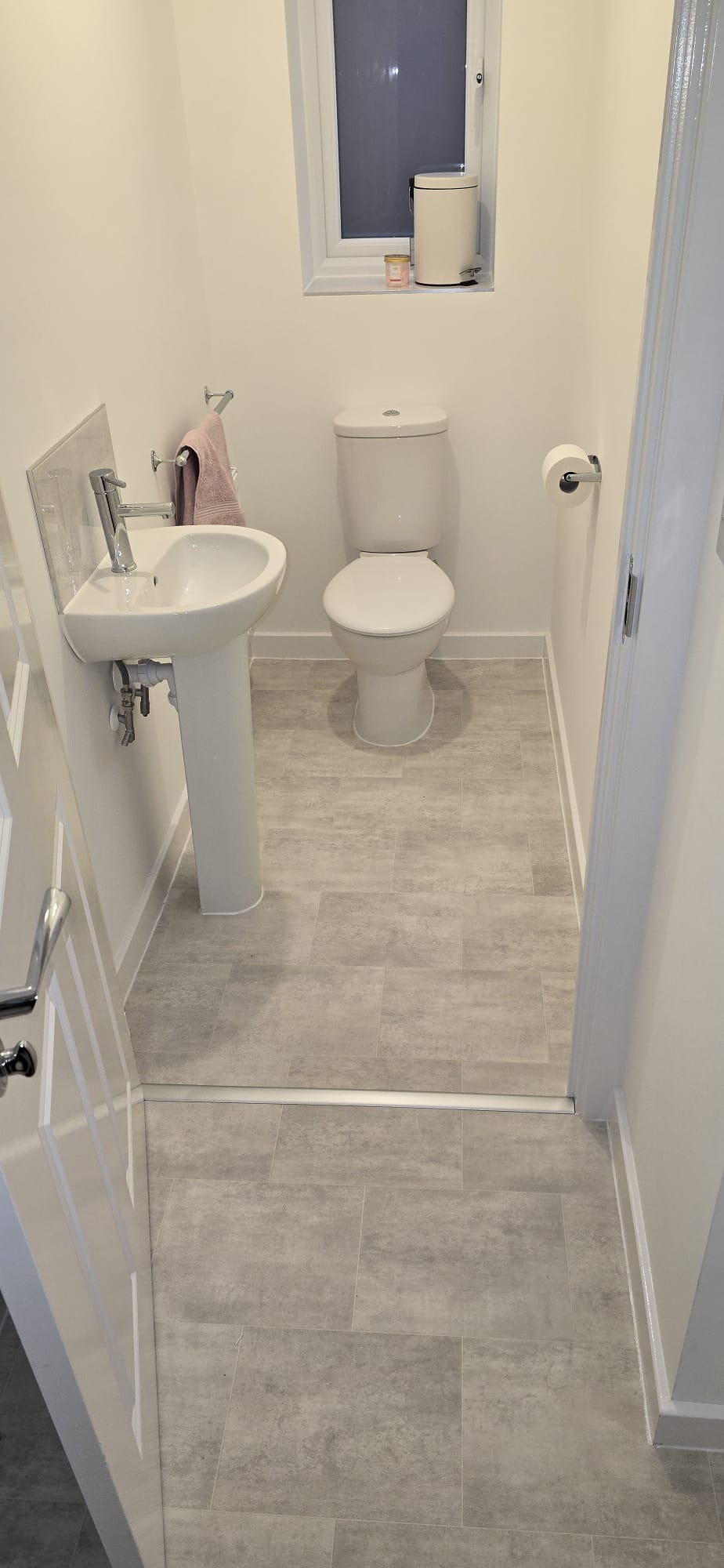 Stone tile-effect vinyl flooring fitted in a downstairs cloakroom